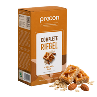 Verpackung der „Complete Riegel CaramelBar“ von Anona GmbH mit Abbildungen von Karamell, Haferriegeln, Haferflocken und Mandeln. Die orange-weiße Verpackung ist mit deutschem Text bedruckt.