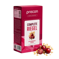 Zu sehen ist eine rote Verpackung der „Complete Riegel CranberryCrisp“-Riegel der Anona GmbH, auf deren Verpackung Cranberries und Getreideflocken abgebildet sind. Neben der Verpackung liegen frische Cranberries und Getreideflocken.
